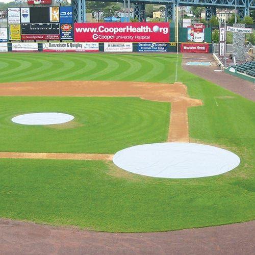 Jaypro Sports baseball tarp covering the home plate area with ground stakes securely placed