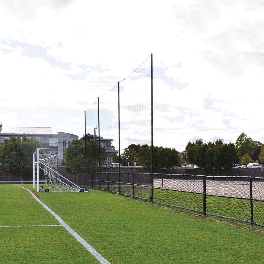 Jaypro Sports FieldPro Soccer Net System FNSB-65 behind soccer goals, keeping balls in play area